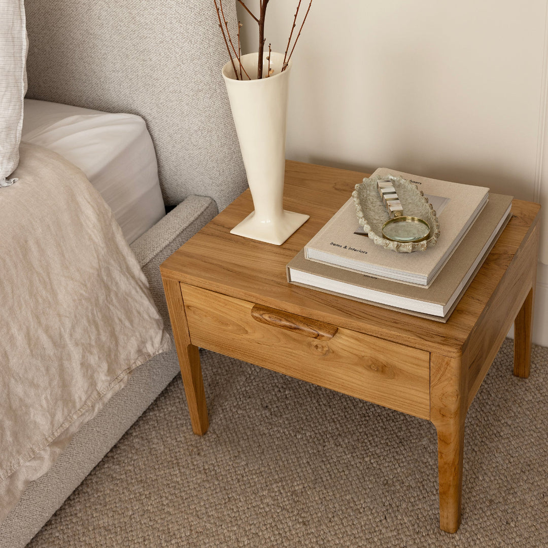 Bonnie bedside table styled next to bed by Ocean Luxe