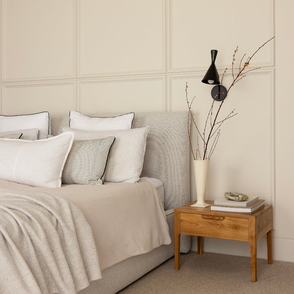 Bonnie bedside table styled next to bed far view by Ocean Luxe