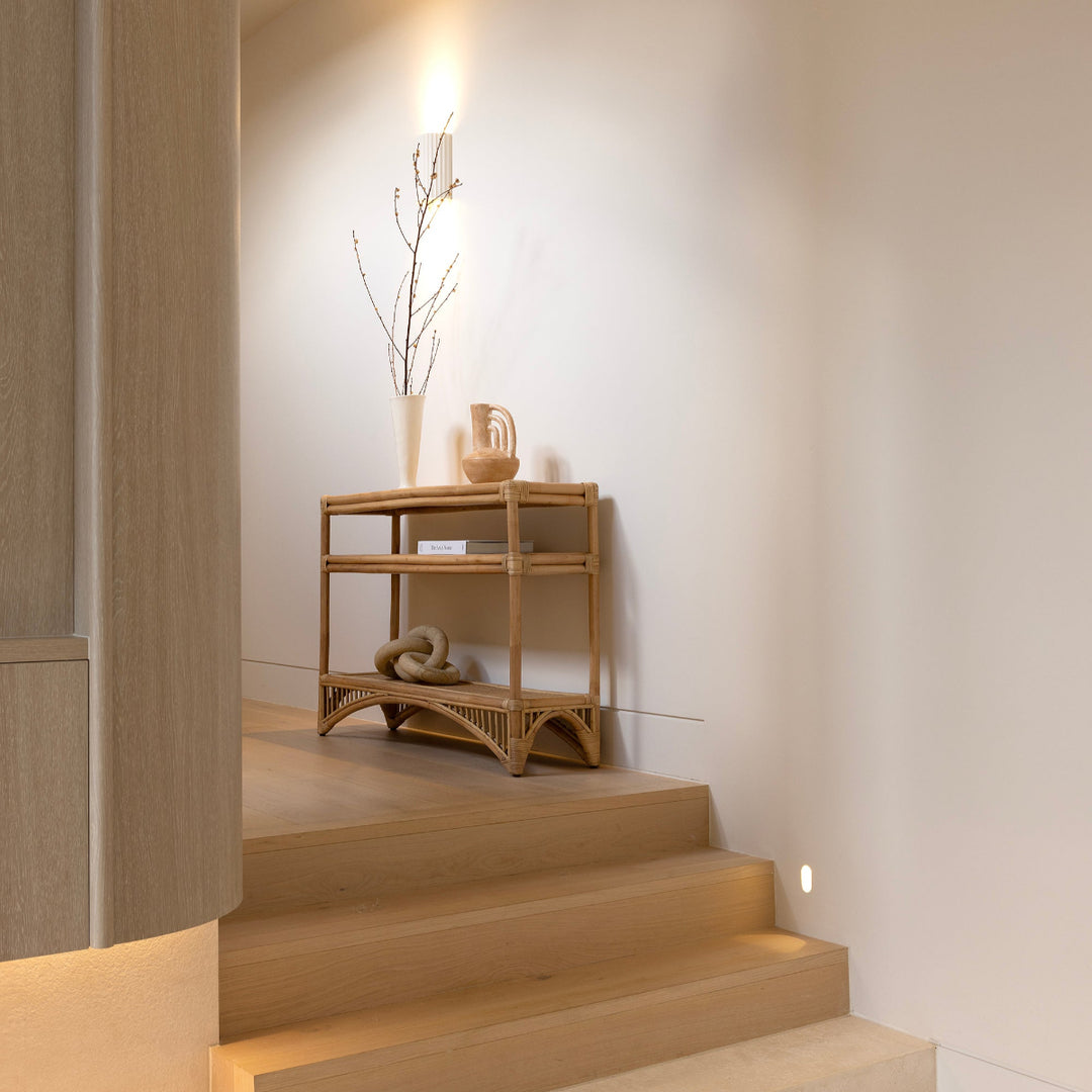 Carmens rattan console in natural positioned in home by Ocean Luxe