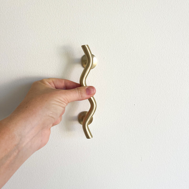 Small brass wave handle for cupboards or doors by Ocean Luxe