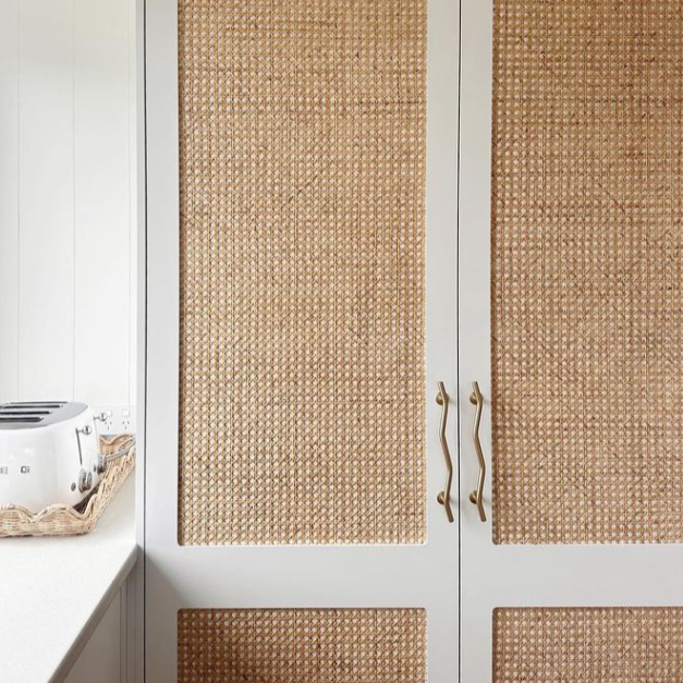 Brass wave handle on rattan cupboard by Ocean Luxe