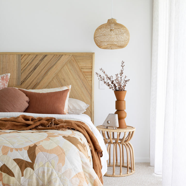 Canberra rattan pendant light above bedside table by Ocean Luxe